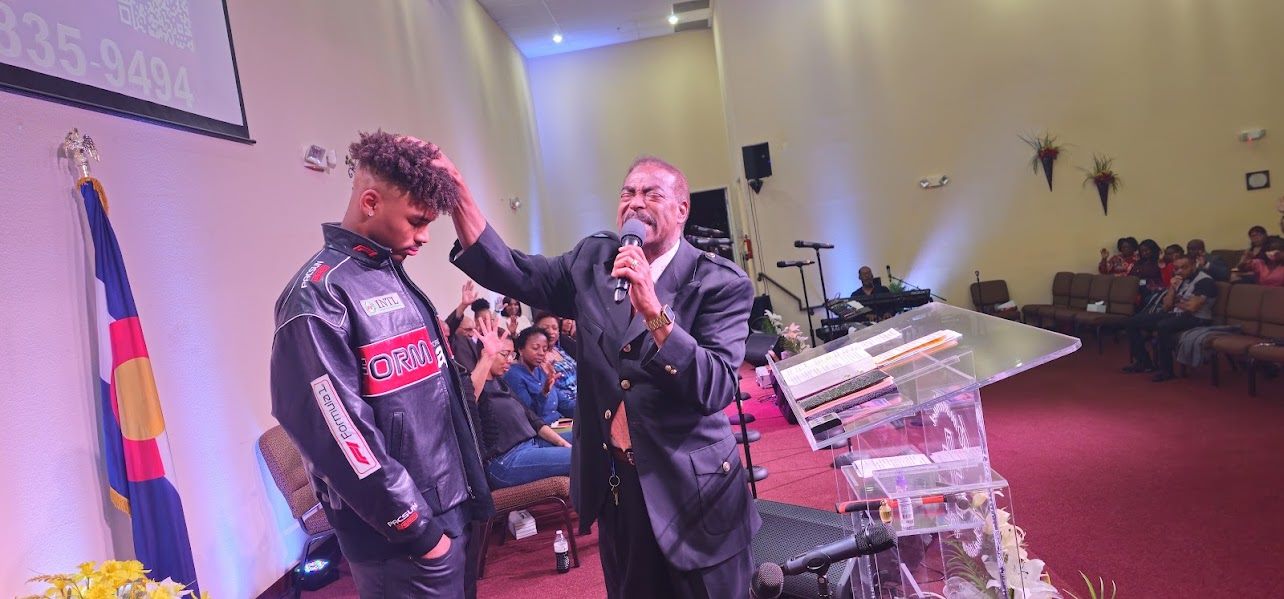 Pastor praying over a member during a hospital visit