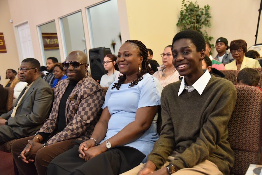 A family sitting together during service at Emmanuel Christian Center
